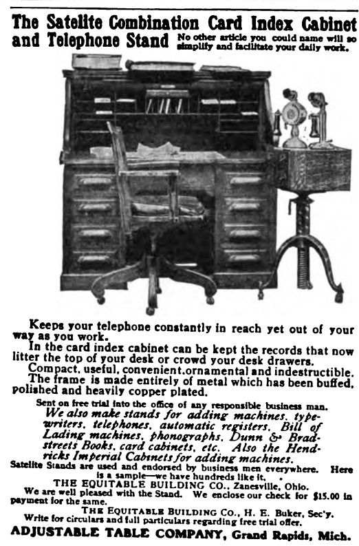 1906 Advertisement for a combination card index table and telephone stand featuring a desk with the satellite combination table next to it.
